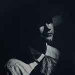 Painting of a man in the traditional Mexican Charro attire, with shadows cast across his upper body and face.