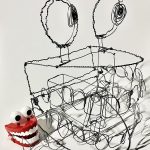 A sculpture constructed of silver wire, representing a chatter-teeth toy with large, round eyes on top with a white background.