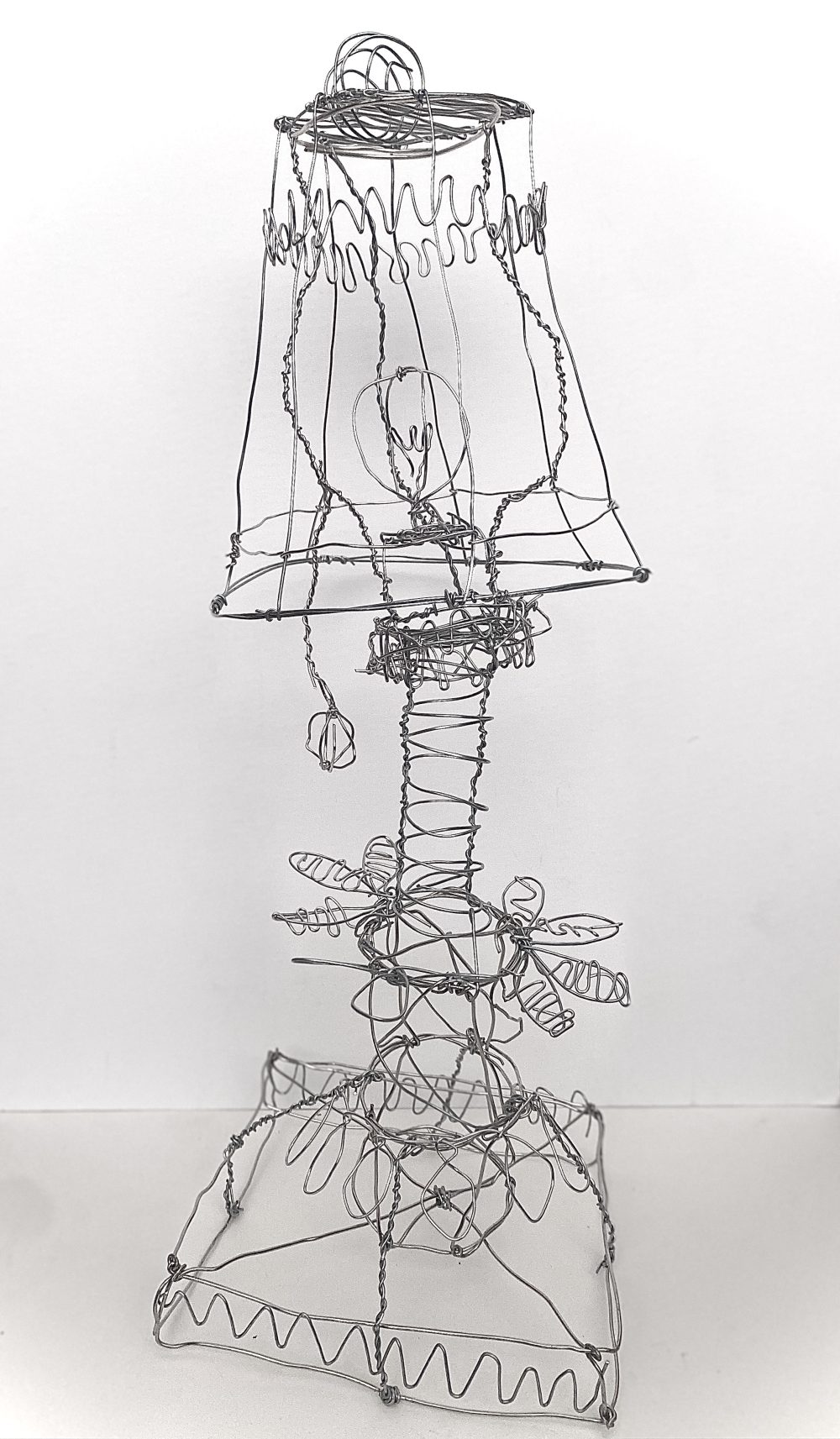 A wire sculpture of a lamp.