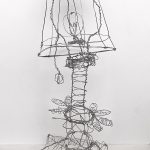 A wire sculpture of a lamp.