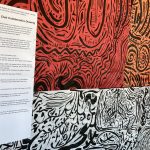 Large-scale black line drawings on colorful paper hanging on the gallery walls.