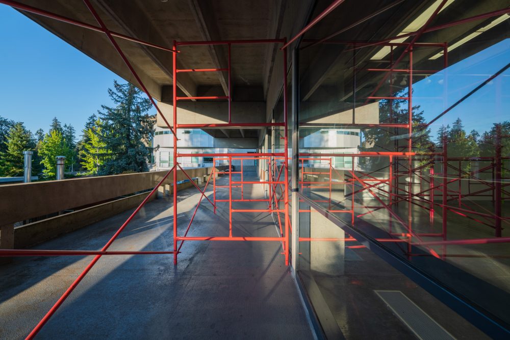 Pink scaffolding outside on the walkway.