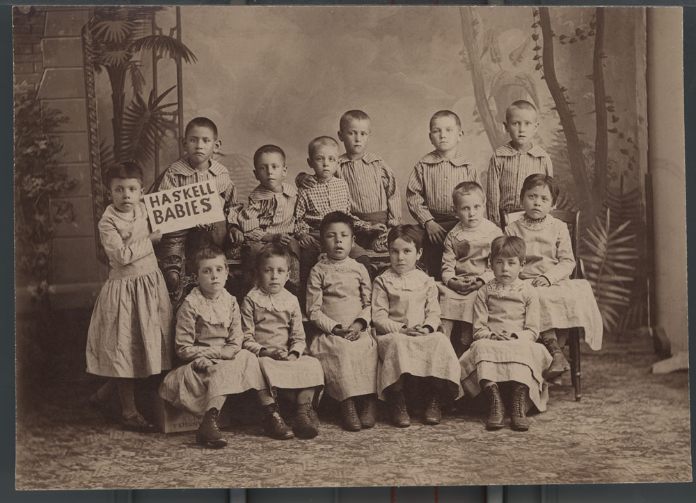 Photograph of young children holding the sign "Haskell Babies".