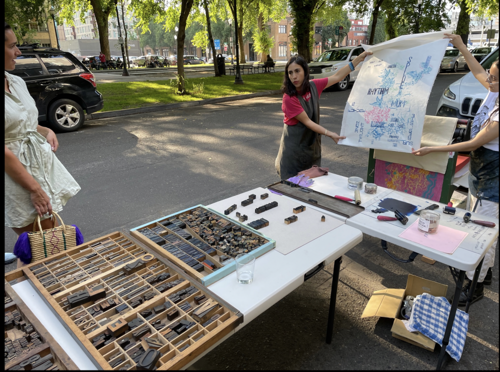 Photograph of a letterpress set up outside in a park.