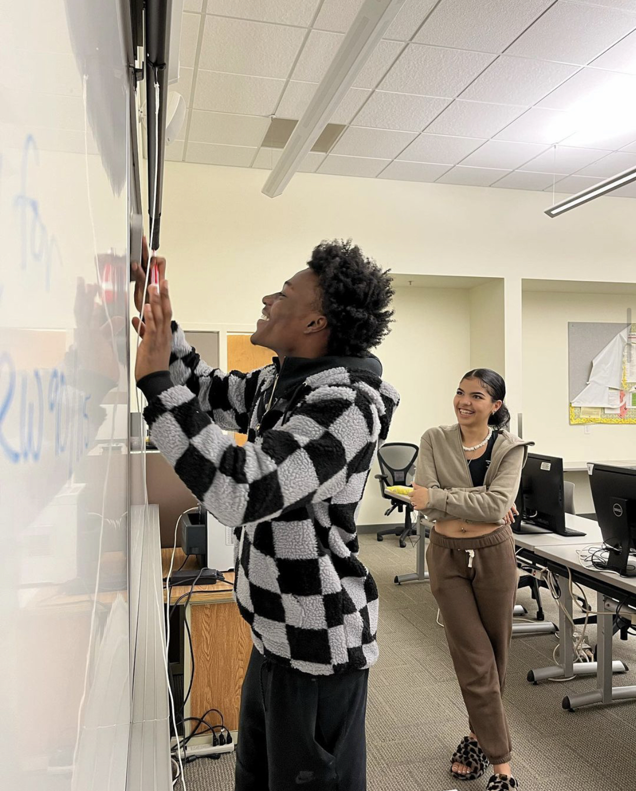 Students writing on whiteboard