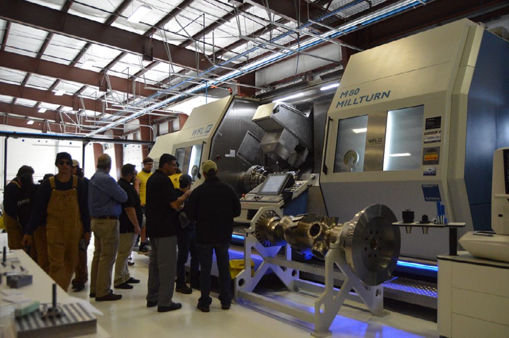 Students with machinery at manufacturing day.