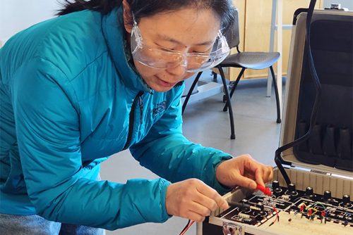 Woman working with electronics equipment