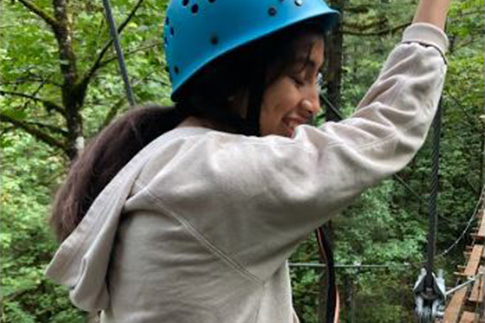 Woman wearing a helmet at a ropes course