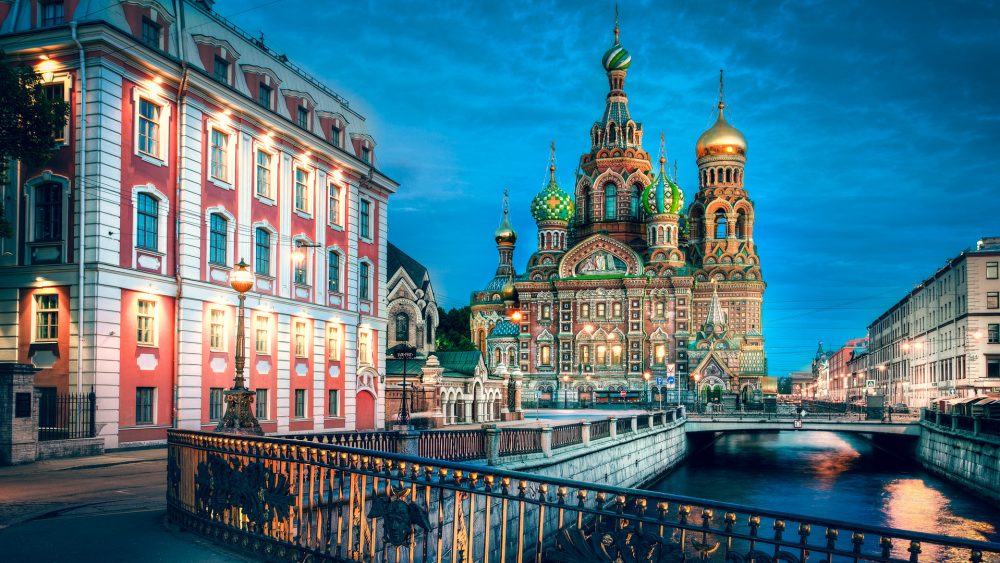 Photograph of buildings, a bridge, St. Basil's cathedral in St. Petersburg, Russia