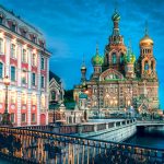 Photograph of buildings, a bridge, St. Basil's cathedral in St. Petersburg, Russia