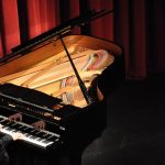 Decorative image of Grand Piano in Performing Arts Center
