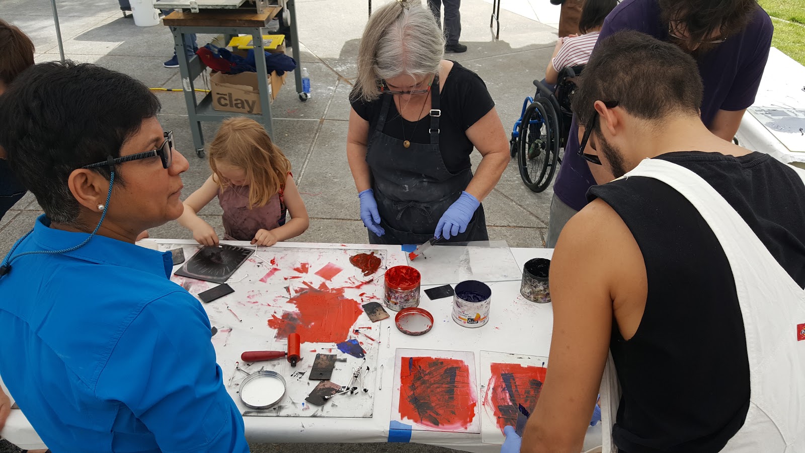 People doing art on a group table