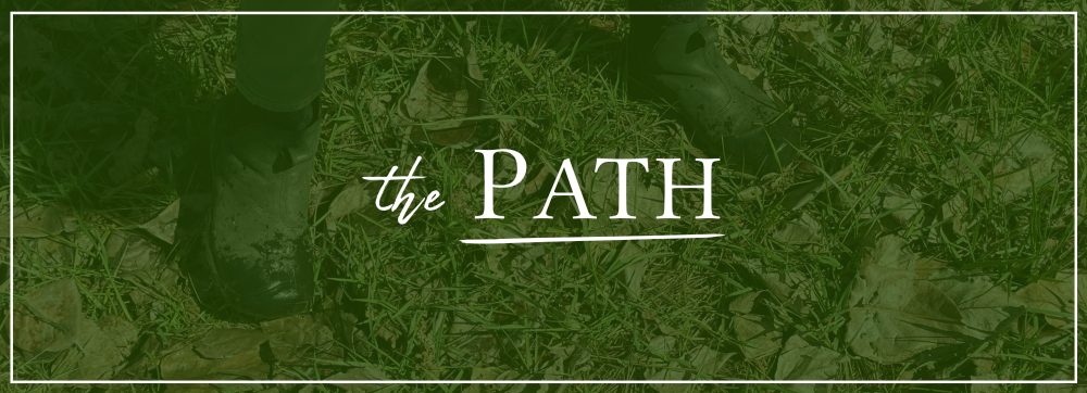 A green photo of boots in grass that says "The Path" in white text