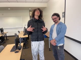 Alumnus and music industry professional James Hickey poses with a student during his class visit