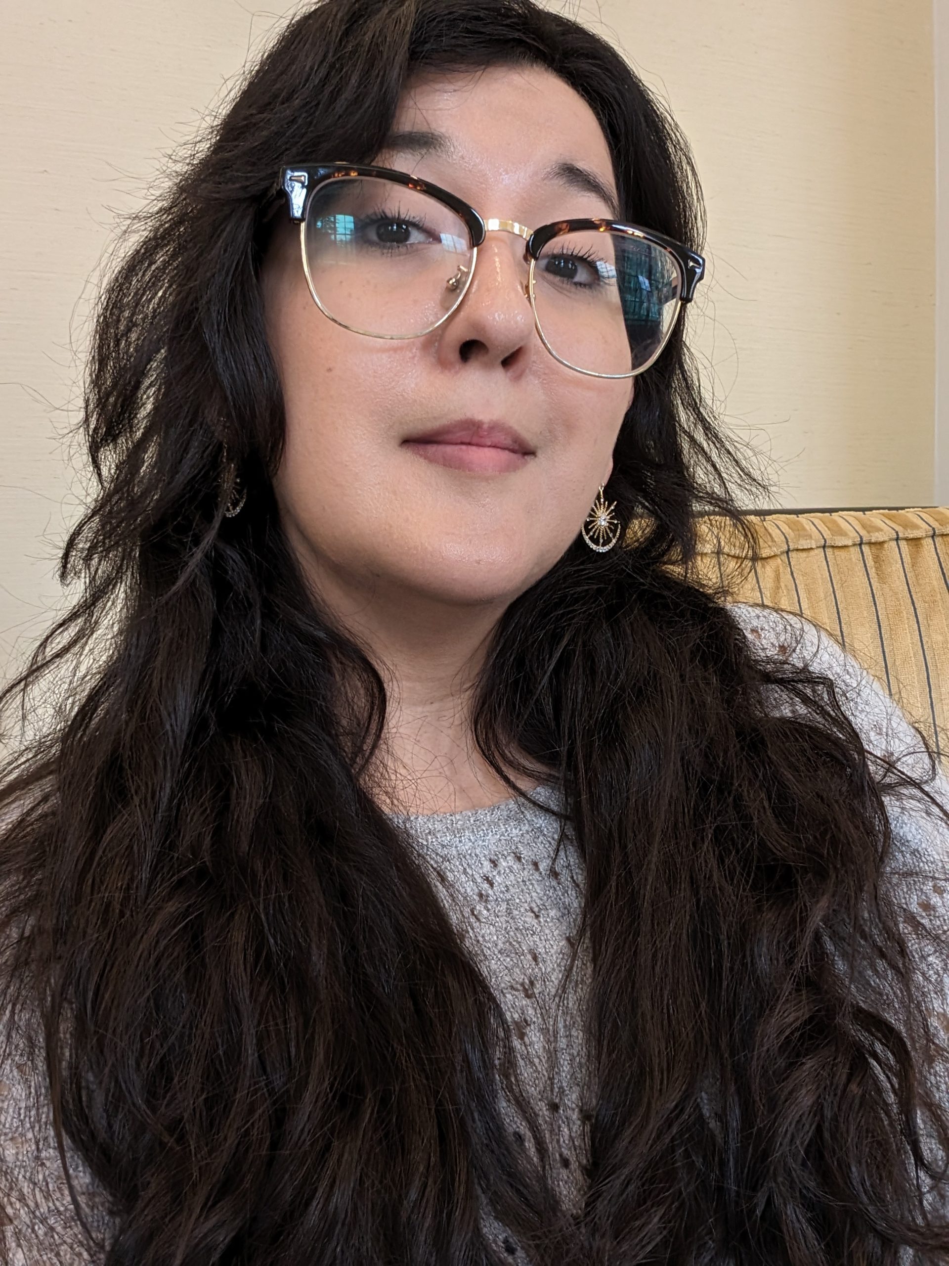 Laura Villareal wears glasses and looks towards the camera