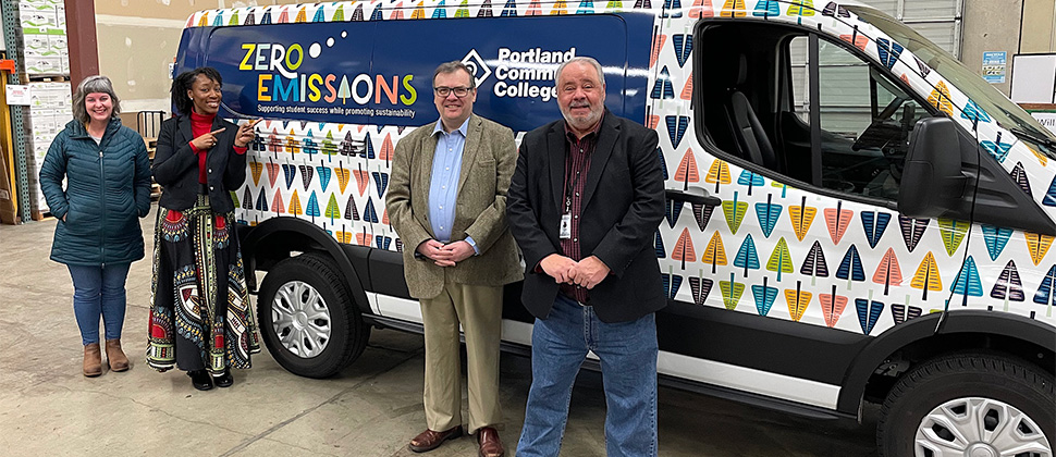 Dr. Adrien Bennings posing with PCC's zero emissions van