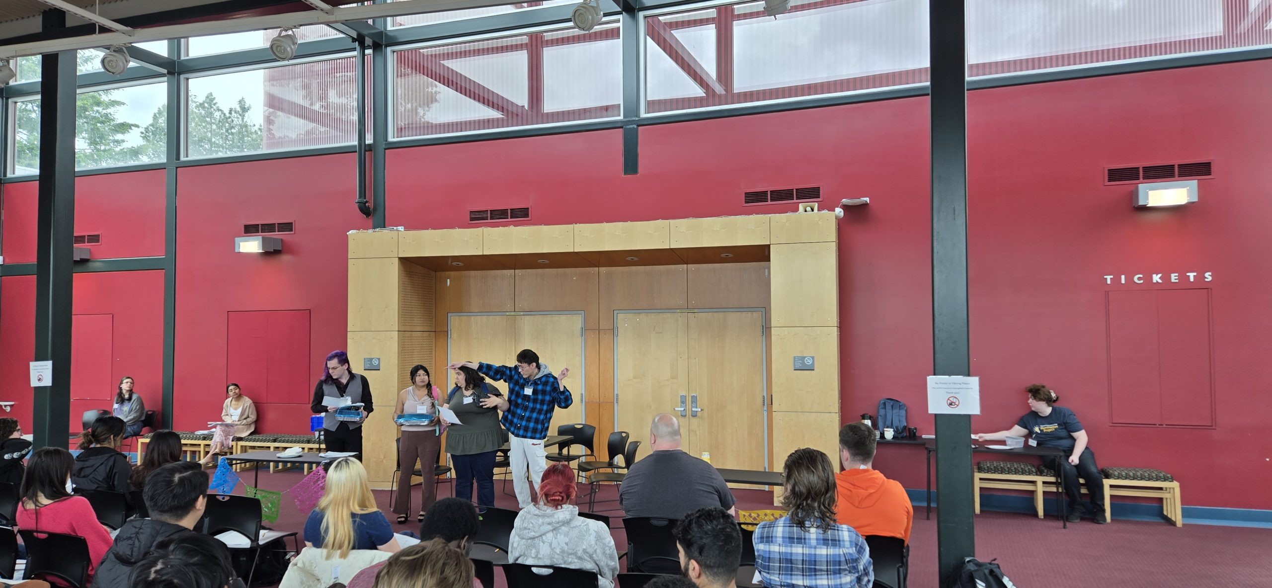 students in action performing in the PAC lobby with audience and instructors helping