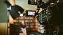 professional video camera in library recording a talk