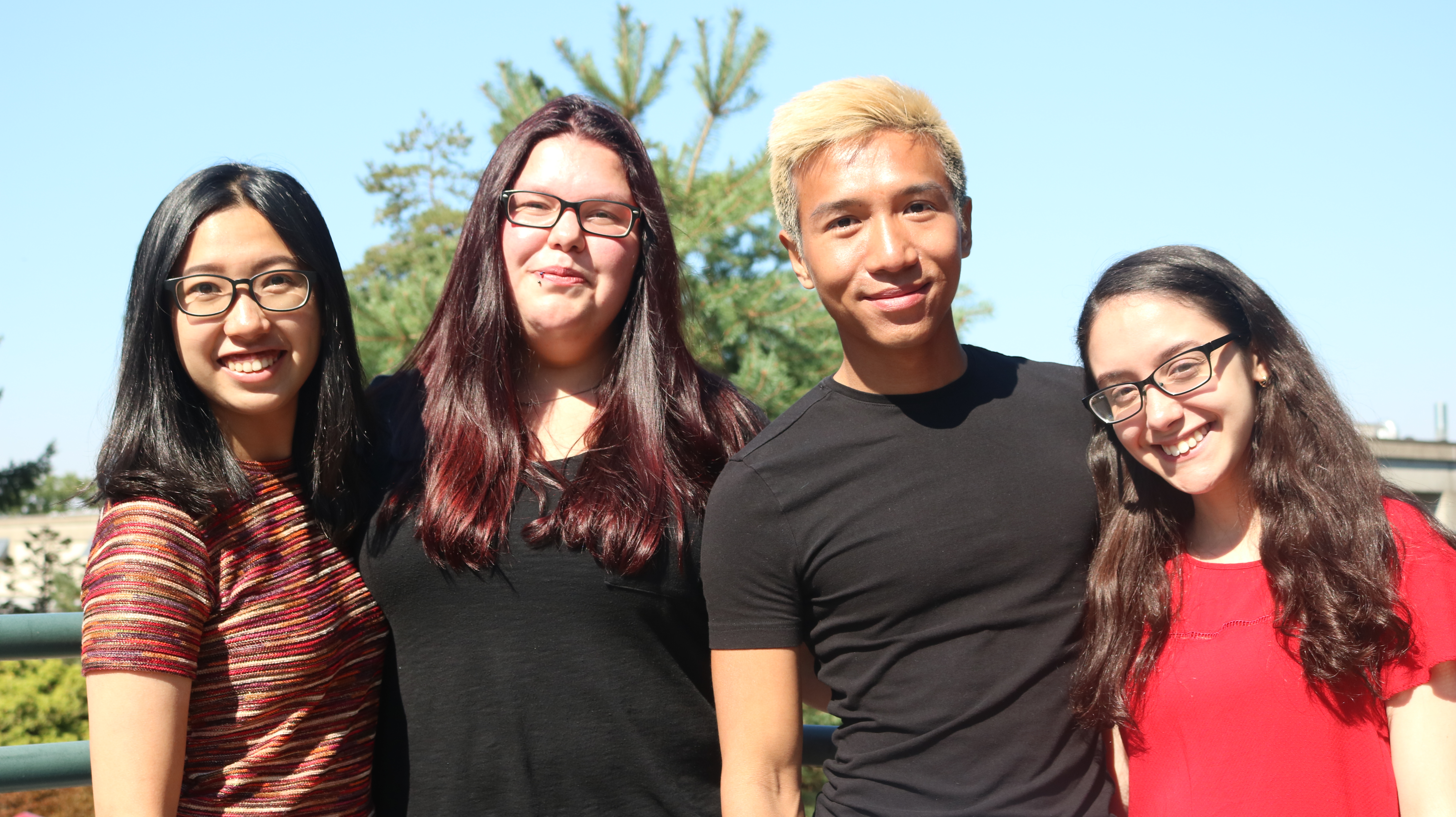 Four international student leaders stranding side by side smiling.