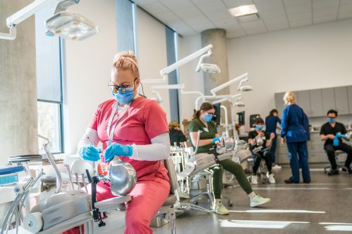 Dental clinic with several chairs and students