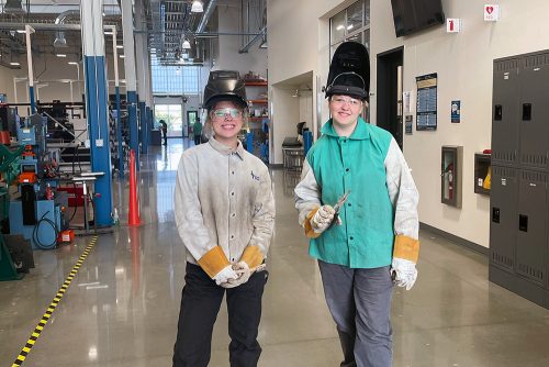 Students in the facility wearing protective clothing and gear