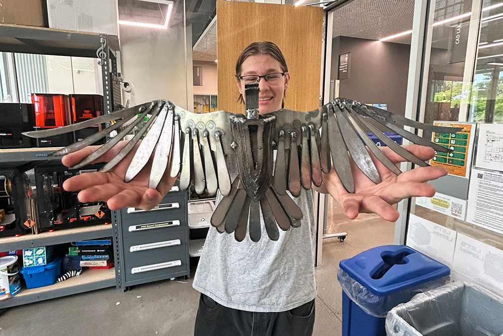 Student holding a metal bird project