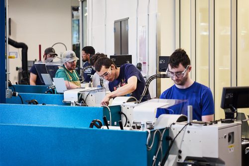 Machine Manufacturing students working at equipment