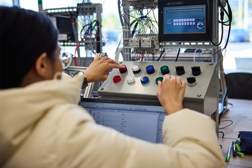 Prog controller student working with equipment