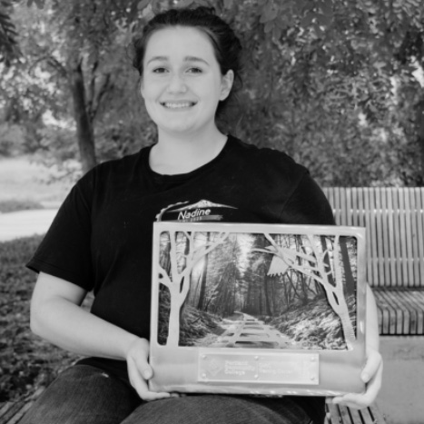 Student holding an award