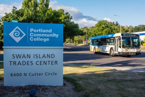 Swan Island sign with TriMet bus driving by