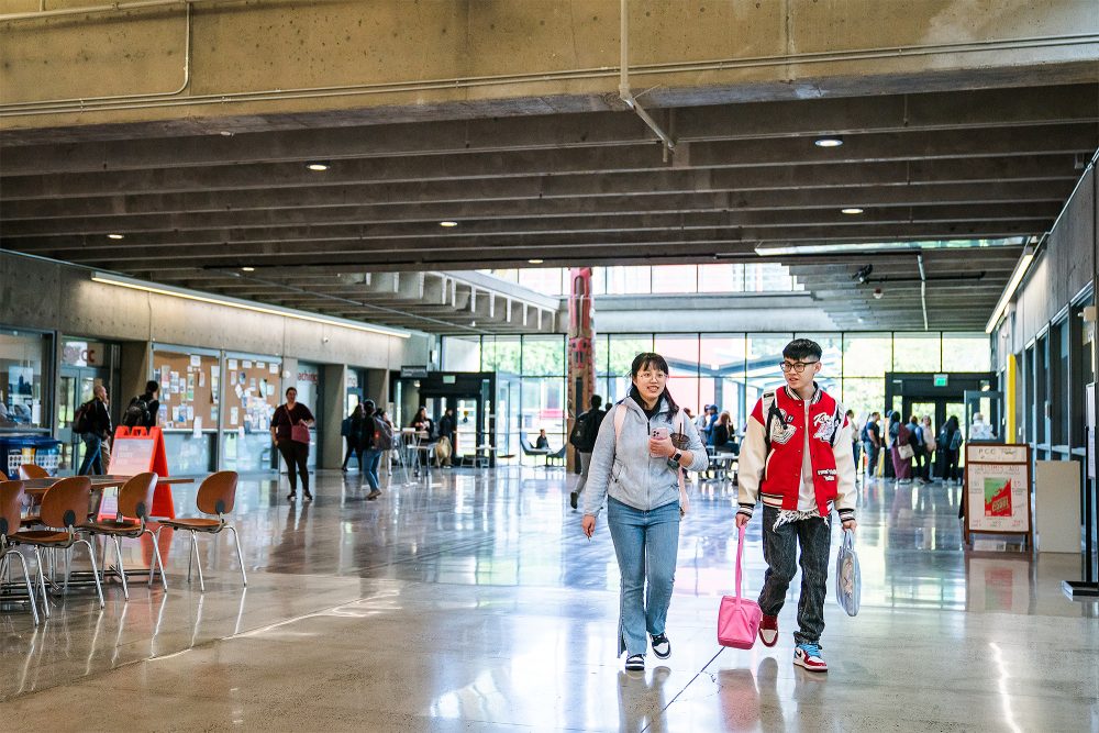 Students walking near the campus totem pole
