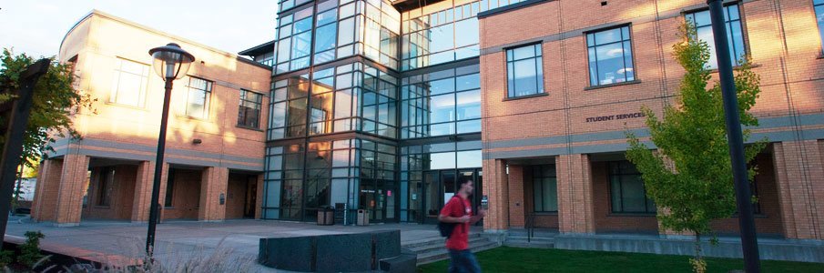 Outdoor brick and glass building with students