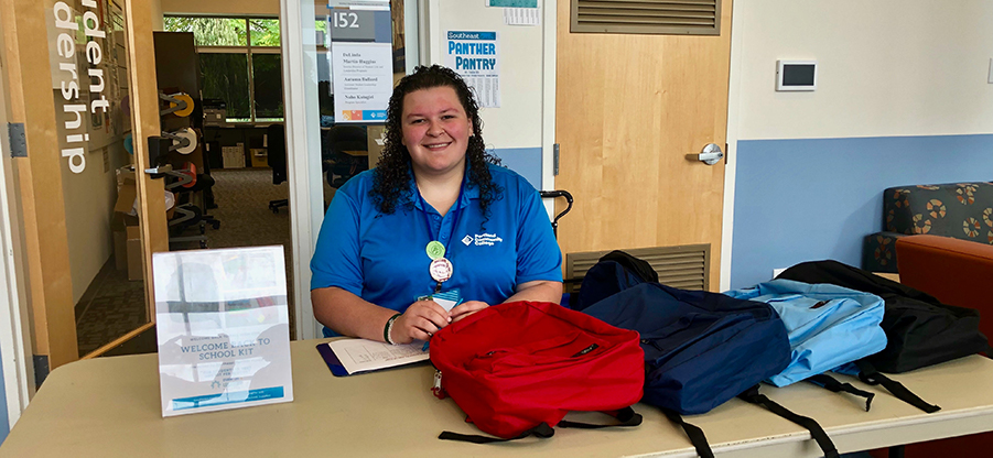 Woman with table full of several new backpacks