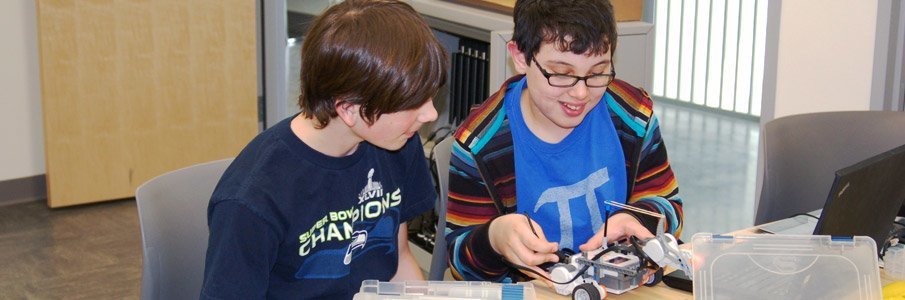 Youth students smiling with model cars