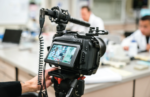 A photo of a video camera capturing video in a classroom.