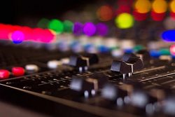 Close-up of soundboard audio equipment