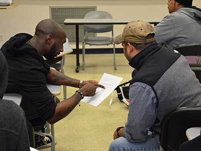 Students discussing over a piece of paper