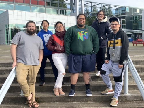 A picture of 6 SY MC Student Leaders standing on the stairs at the SY campus in the courtyard out front of the PAC.