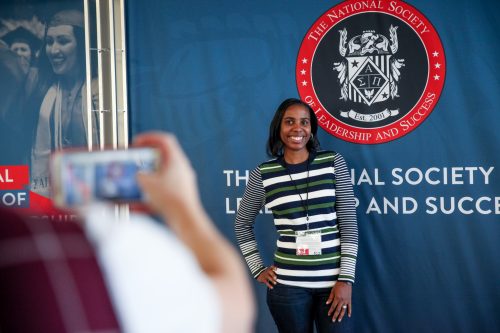 student standing in front of NSLS logo