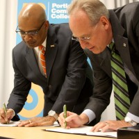 PCC District President Preston Pulliams (left) and PSU President Wim Wiewel sign the new dual enrollment agreement.