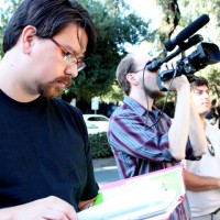 Robin Mihara, left, checks his notes during production of 'Ecstasy of Order: The Tetris Masters.'