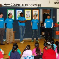 PCC students along with Southeast Interim President Craig Kolins (far left) talk to first and second graders at Adler Elementary for College Adoption Day.
