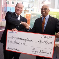 Roger Hinshaw (left), Bank of America President for Oregon and Southwest Washington, hands over the big check to PCC District President Preston Pulliams.