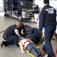 Paramedics with Hillsboro Fire demonstrate caring for one of the high-tech mannequins associated with the simulation vehicle.