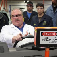 Automotive Service Technology instructor Russ Jones shows first term students the dangers of working on high voltage hybrid batteries.