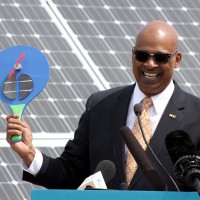 PCC District President Preston Pulliams holds up a solar-power paddle fan, a gift to invited guest at the solar array unveiling on Friday, May 18 at the Rock Creek Campus.