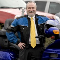 David Rule with his motorycle he rides to work on every day.