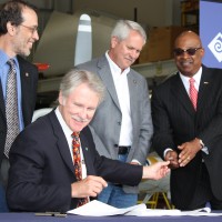Gov. John Kitzhaber (seated) is seen here with PCC President Preston Pulliams (right) signing several education bills at the Rock Creek Campus in 2011.