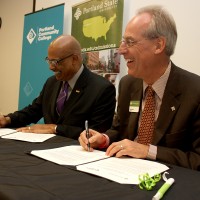 Right to left, PSU President Wim Wiewel and PCC President Preston Pulliams officially sign the agreement