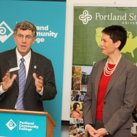 Representatives from the Oregon University System and Community College Workforce Development speak to the crowd.